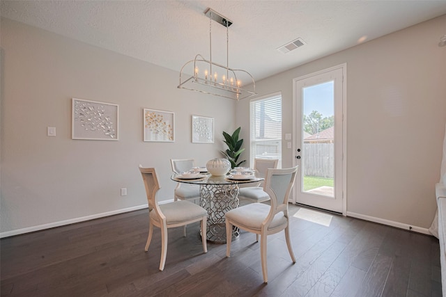 2923 Laurel Mill Way, Houston, TX 77080 - dining space with dark wood-style flooring, a chandelier, baseboards, and a textured ceiling