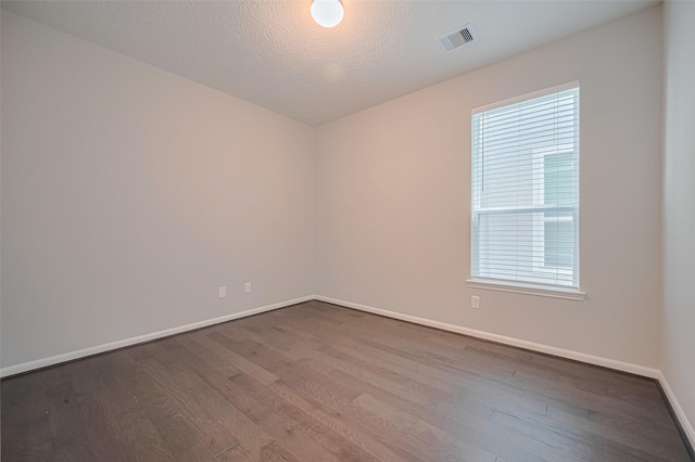 2923 Laurel Mill Way, Houston, TX 77080 - spare room featuring dark wood-style flooring, baseboards, and healthy amount of natural light