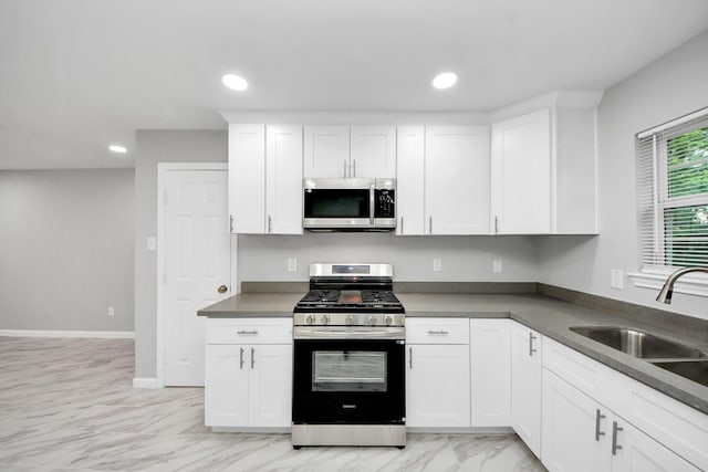 3030 Dacca Dr, Houston, TX 77051 - kitchen featuring stainless steel appliances, a sink, white cabinetry, recessed lighting, and dark countertops