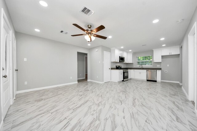 3030 Dacca Dr, Houston, TX 77051 - kitchen featuring stainless steel appliances, recessed lighting, open floor plan, dark countertops, and baseboards