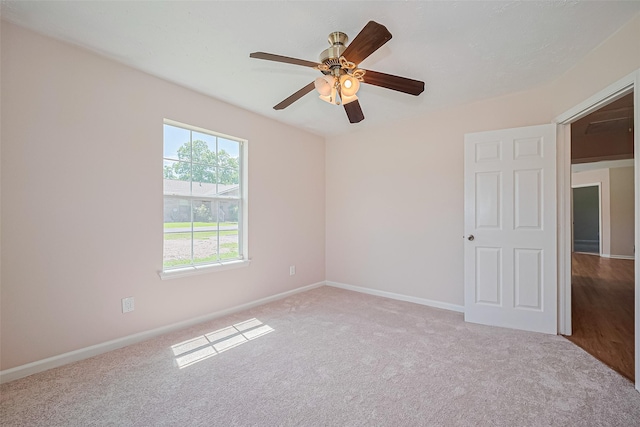 115 N 12th St, Highlands, TX 77562 - spare room featuring carpet, baseboards, and a ceiling fan