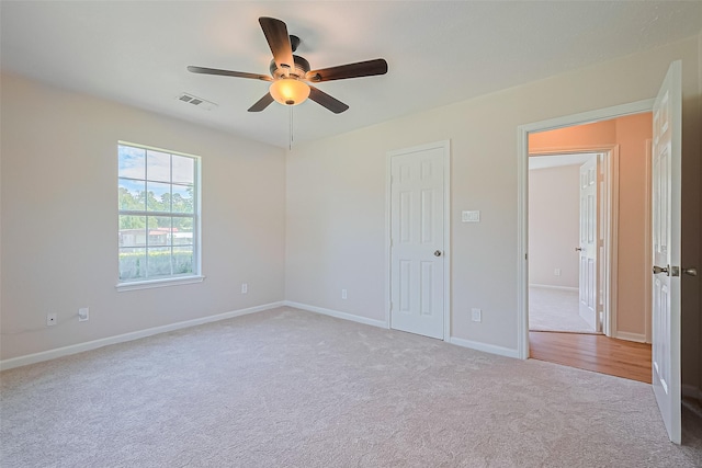 115 N 12th St, Highlands, TX 77562 - unfurnished bedroom featuring carpet, baseboards, and a ceiling fan
