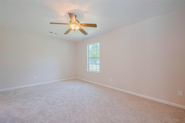 115 N 12th St, Highlands, TX 77562 - empty room with light colored carpet, baseboards, and a ceiling fan