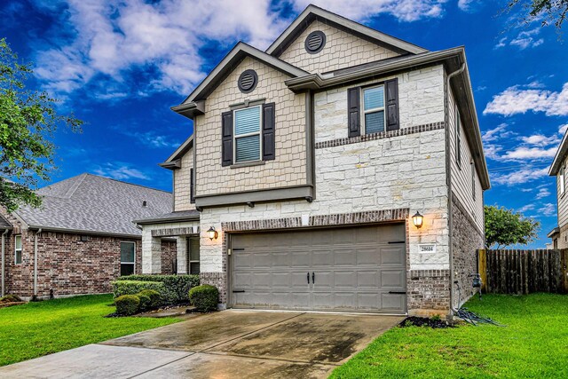 28614 Cabrera Hill Ln, Katy, TX 77494 - view of front of property featuring stone siding, an attached garage, and concrete driveway