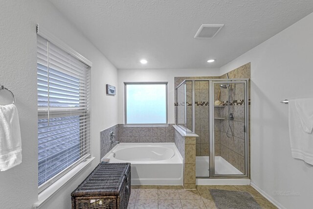 28614 Cabrera Hill Ln, Katy, TX 77494 - bathroom featuring a garden tub, a shower stall, tile patterned flooring, recessed lighting, and a textured ceiling