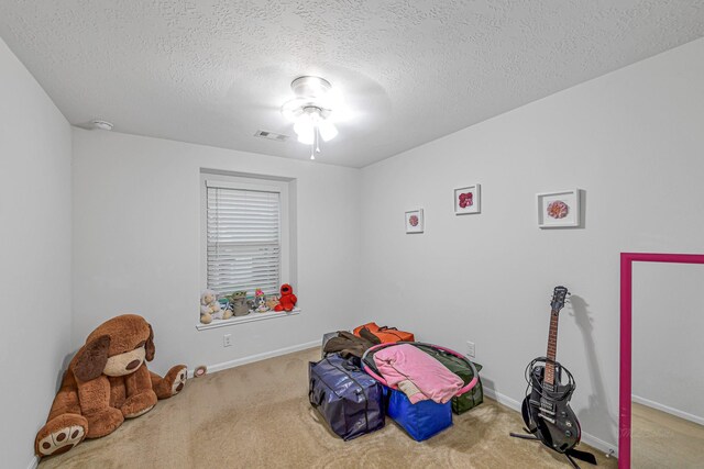 28614 Cabrera Hill Ln, Katy, TX 77494 - recreation room featuring carpet floors, a textured ceiling, and baseboards