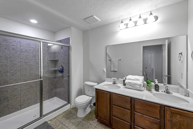 28614 Cabrera Hill Ln, Katy, TX 77494 - bathroom featuring double vanity, toilet, a shower stall, tile patterned floors, and a textured ceiling