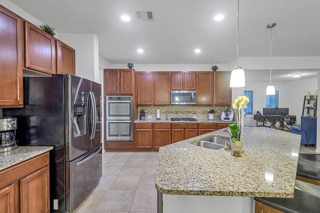28614 Cabrera Hill Ln, Katy, TX 77494 - kitchen featuring appliances with stainless steel finishes, recessed lighting, a sink, light stone countertops, and decorative light fixtures