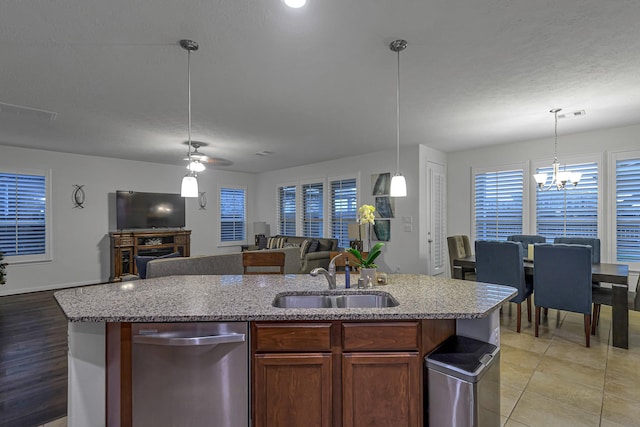 28614 Cabrera Hill Ln, Katy, TX 77494 - kitchen featuring dishwasher, a sink, open floor plan, and plenty of natural light