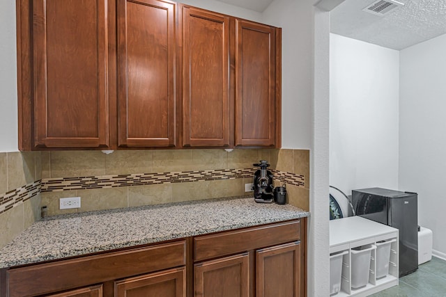 28614 Cabrera Hill Ln, Katy, TX 77494 - kitchen with tasteful backsplash, light stone counters, and tile patterned flooring