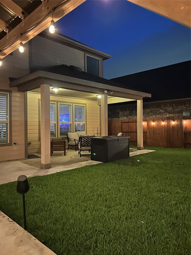 28614 Cabrera Hill Ln, Katy, TX 77494 - back of house at twilight featuring an outdoor hangout area and a patio area