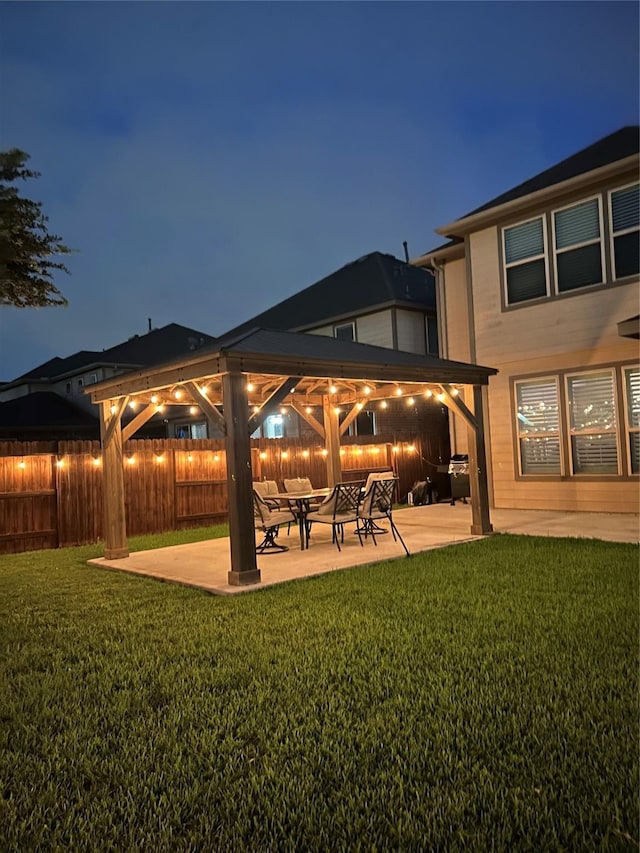 28614 Cabrera Hill Ln, Katy, TX 77494 - back of house at twilight with a gazebo and a patio