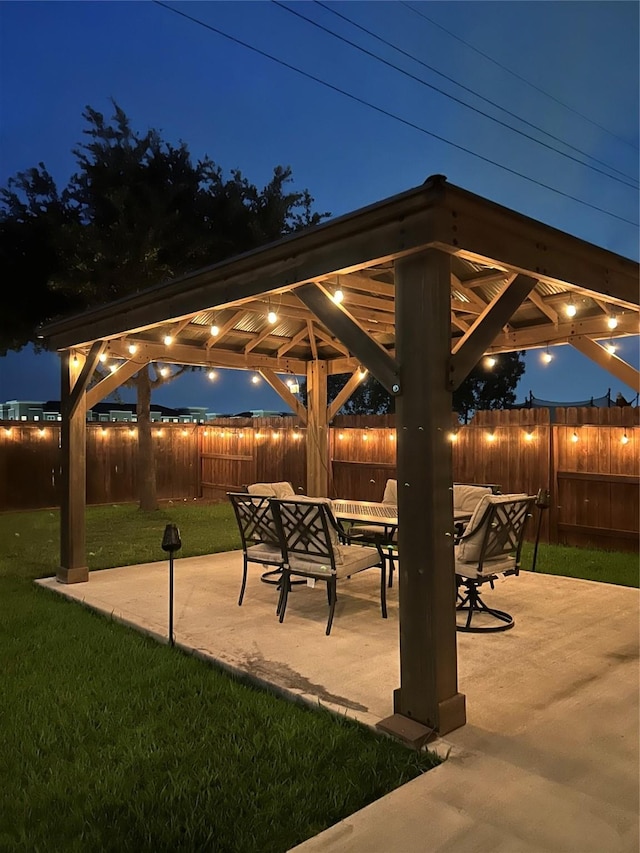 28614 Cabrera Hill Ln, Katy, TX 77494 - patio at night featuring a gazebo, a patio, and outdoor dining area