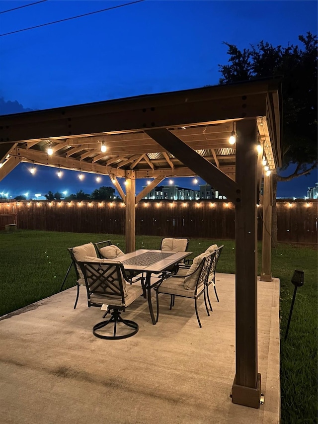 28614 Cabrera Hill Ln, Katy, TX 77494 - patio at night with outdoor dining space and a patio area