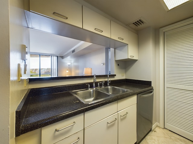 3525 Sage Rd Unit 412, Houston, TX 77056 - kitchen featuring stainless steel dishwasher, a sink, white cabinets, light tile patterned flooring, and dark countertops