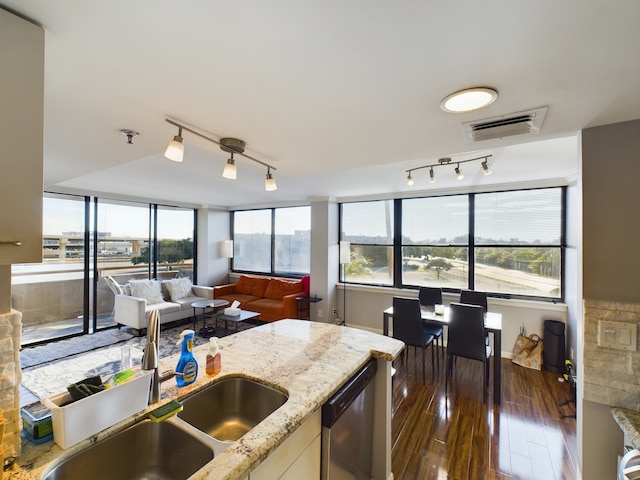 3525 Sage Rd Unit 403, Houston, TX 77056 - kitchen with dishwasher, a sink, track lighting, dark wood-style flooring, and light stone countertops