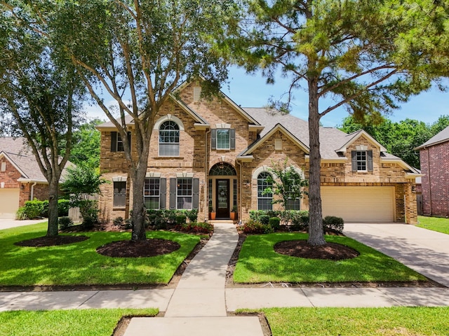 4611 Kings Landing Ln, Katy, TX 77494 - traditional-style house featuring a front lawn, concrete driveway, brick siding, and roof with shingles