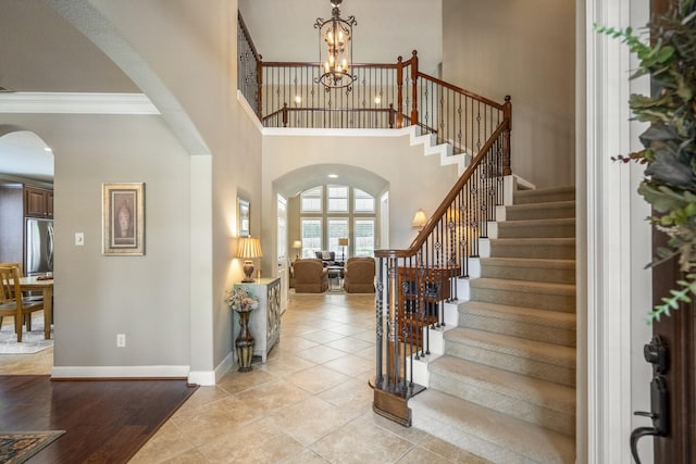 4611 Kings Landing Ln, Katy, TX 77494 - entrance foyer featuring arched walkways, stairway, a chandelier, crown molding, and baseboards