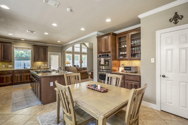 4611 Kings Landing Ln, Katy, TX 77494 - dining space featuring crown molding, recessed lighting, light tile patterned floors, and arched walkways