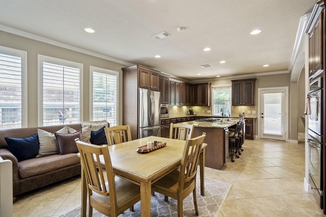 4611 Kings Landing Ln, Katy, TX 77494 - dining space featuring crown molding, recessed lighting, light tile patterned floors, and baseboards