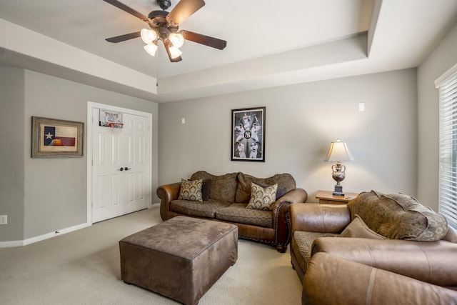 4611 Kings Landing Ln, Katy, TX 77494 - living area featuring a ceiling fan, carpet, baseboards, and a tray ceiling