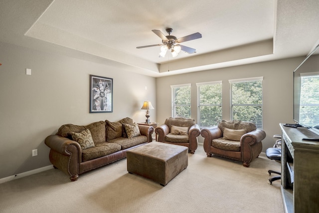 4611 Kings Landing Ln, Katy, TX 77494 - living area with a raised ceiling, light colored carpet, ceiling fan, and baseboards