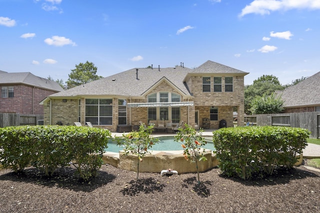 4611 Kings Landing Ln, Katy, TX 77494 - back of property featuring brick siding, a fenced backyard, a patio area, and an outdoor pool