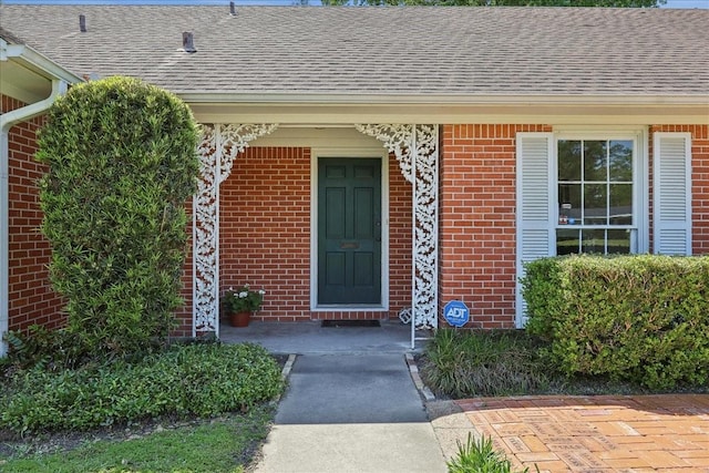 1175 N 23rd St, Beaumont, TX 77706 - entrance to property featuring roof with shingles and brick siding