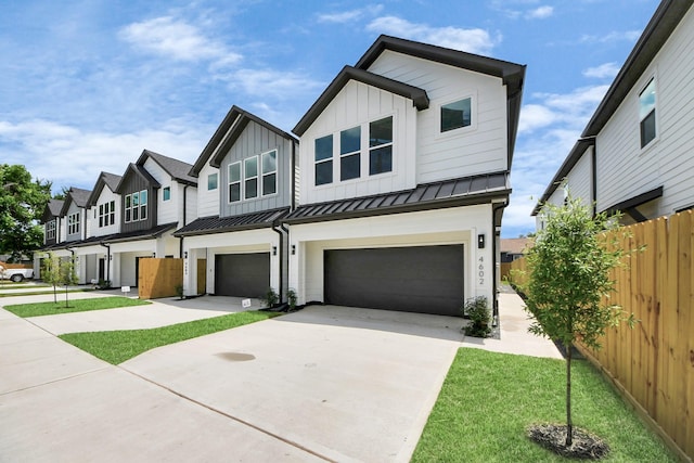 4602 Bristol St, Houston, TX 77009 - view of property featuring concrete driveway, a garage, a standing seam roof, board and batten siding, and a residential view