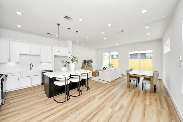 4602 Bristol St, Houston, TX 77009 - kitchen with a sink, recessed lighting, stainless steel appliances, light wood-style flooring, and a kitchen island