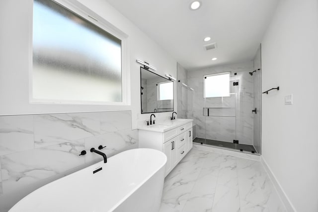 4602 Bristol St, Houston, TX 77009 - full bathroom featuring a freestanding bath, recessed lighting, a marble finish shower, marble finish floors, and double vanity