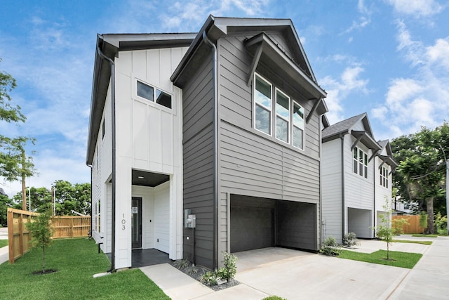103 Frawley St, Houston, TX 77009 - view of front of home with a garage, board and batten siding, and driveway