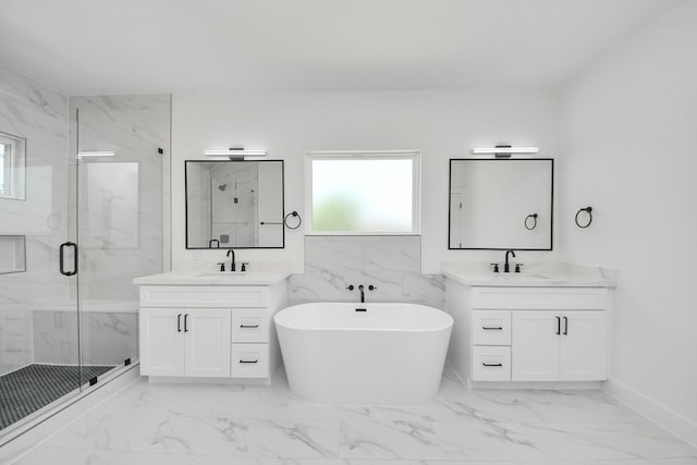 103 Frawley St, Houston, TX 77009 - bathroom featuring marble finish floors, a marble finish shower, a soaking tub, and two vanities