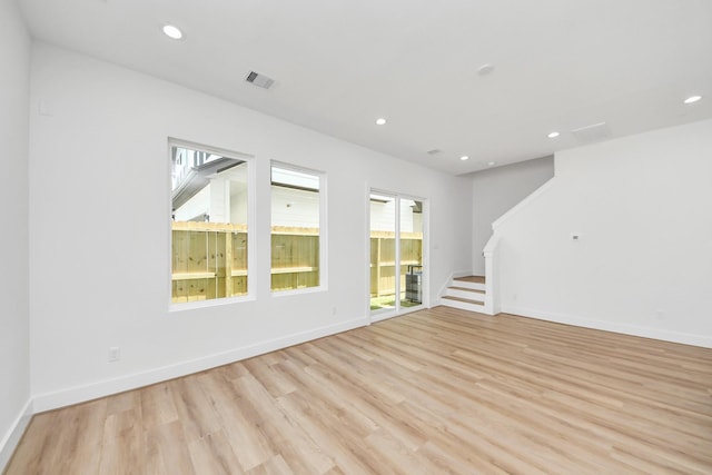 103 Frawley St, Houston, TX 77009 - empty room featuring light wood-style flooring, stairway, recessed lighting, and baseboards