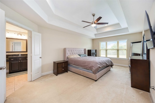 5142 Oasis Park, Houston, TX 77021 - bedroom with a tray ceiling, light carpet, baseboards, ensuite bath, and a ceiling fan