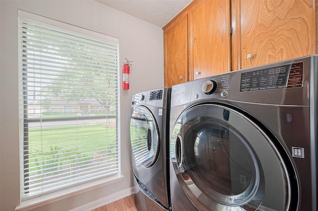 334 Swords Bnd, Stafford, TX 77477 - laundry room featuring cabinet space, independent washer and dryer, and a textured ceiling