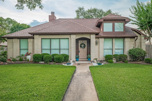 334 Swords Bnd, Stafford, TX 77477 - view of front facade with brick siding, a front lawn, and roof with shingles