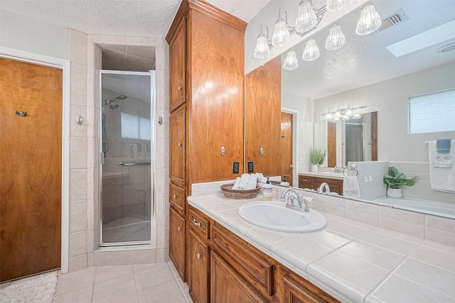 334 Swords Bnd, Stafford, TX 77477 - full bath with a stall shower, vanity, a skylight, a textured ceiling, and tile patterned flooring