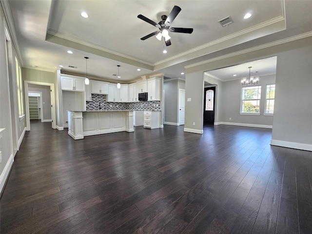 4319 Trail Lake Dr, Houston, TX 77045 - unfurnished living room with a chandelier, ceiling fan, dark wood-type flooring, baseboards, and a raised ceiling
