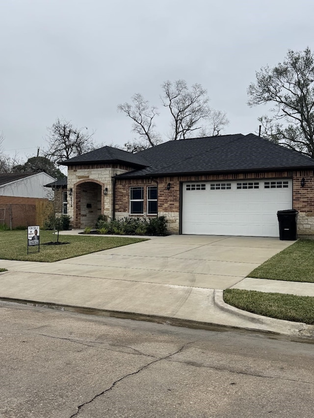 4319 Trail Lake Dr, Houston, TX 77045 - view of front of house featuring a garage, brick siding, driveway, and a shingled roof