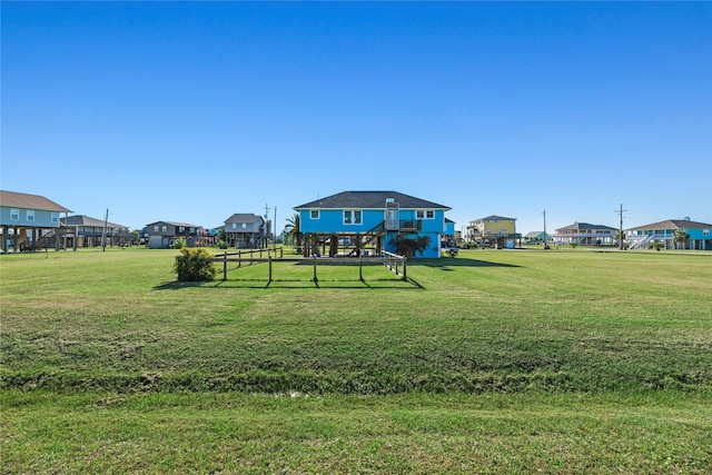 117 S Verdia Dr, Crystal Beach, TX 77650 - view of green lawn featuring a residential view