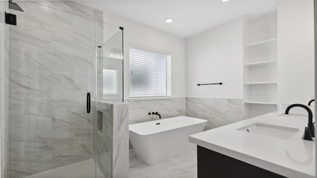 723 Marcella St Unit B, Houston, TX 77091 - full bathroom featuring a stall shower, a soaking tub, double vanity, marble finish floors, and tile walls