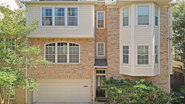 2913 Jackson St, Houston, TX 77004 - view of front of home featuring brick siding, an attached garage, and driveway
