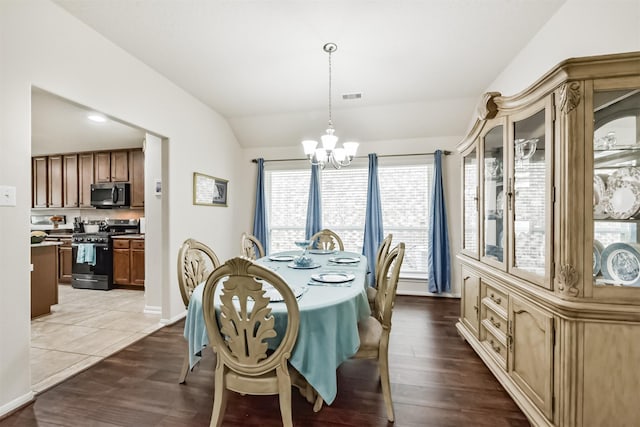 4223 Leafy Bough Ct, Humble, TX 77346 - dining room featuring a chandelier, lofted ceiling, wood finished floors, and baseboards