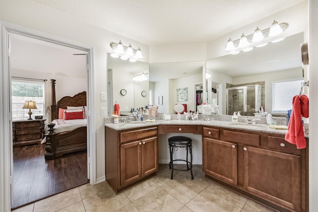 4223 Leafy Bough Ct, Humble, TX 77346 - ensuite bathroom featuring double vanity, a shower stall, and tile patterned floors