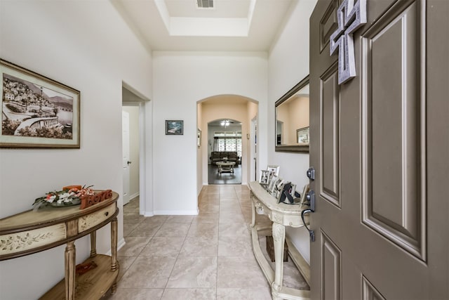 4223 Leafy Bough Ct, Humble, TX 77346 - entrance foyer with arched walkways, light tile patterned flooring, and a raised ceiling