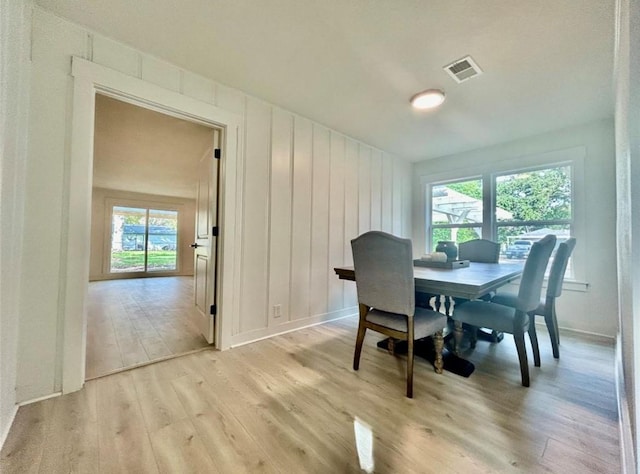 319 Wisteria St, Lake Jackson, TX 77566 - dining space with light wood-type flooring, healthy amount of natural light, and baseboards