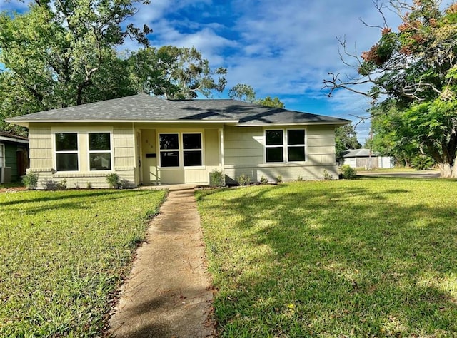 319 Wisteria St, Lake Jackson, TX 77566 - view of front of house with a front lawn, brick siding, and a shingled roof