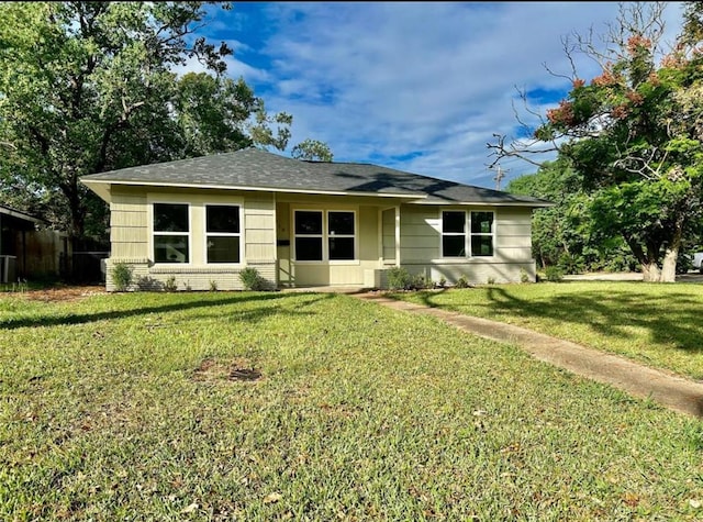 319 Wisteria St, Lake Jackson, TX 77566 - view of front of house with a front lawn, central AC, and a shingled roof