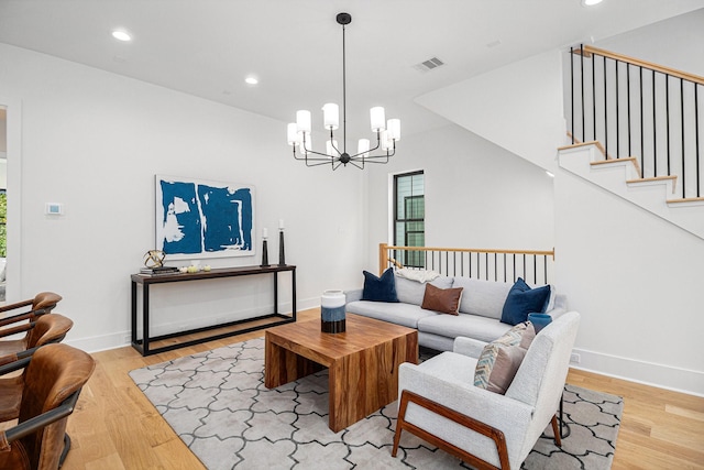 515 E 4th St, Houston, TX 77007 - living room featuring light wood finished floors, a chandelier, recessed lighting, baseboards, and stairway
